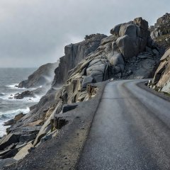 Road edge and bare grey rock along the Havøysund tourist route