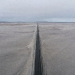 Flat grey glacial outwash plain of Skeiðarársandur with Route 1 crossing it